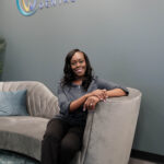 Dr. Crow sitting on a couch in the lobby of Crescent Dental Studio