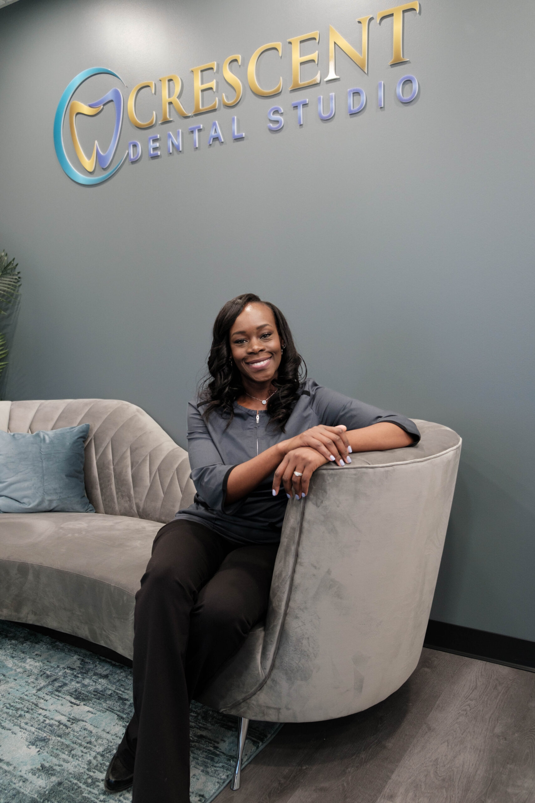 Dr. Crow sitting on a couch in the lobby of Crescent Dental Studio