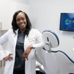 Dr Crow leaning against dental chair at Crescent Dental Studio
