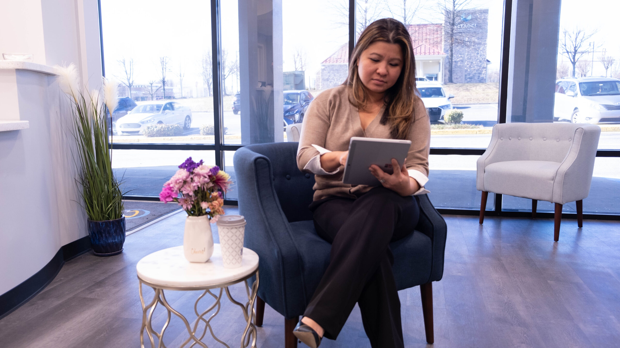 Dental patient enters insurance information in lobby of Crescent Dental Studio